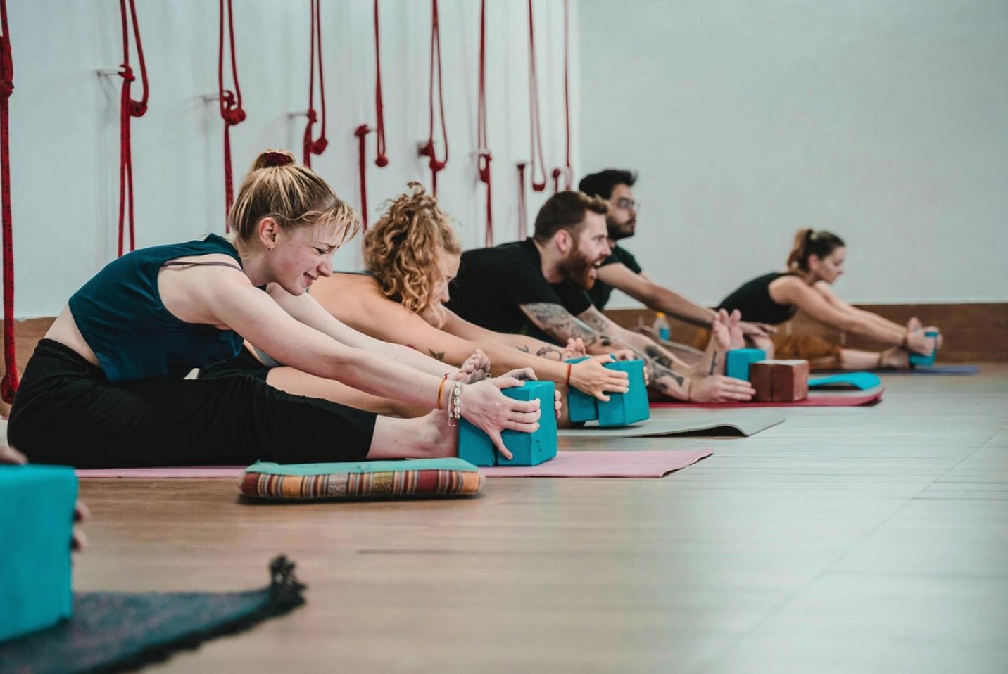 Office yoga session with instructor guiding participants at their workstations