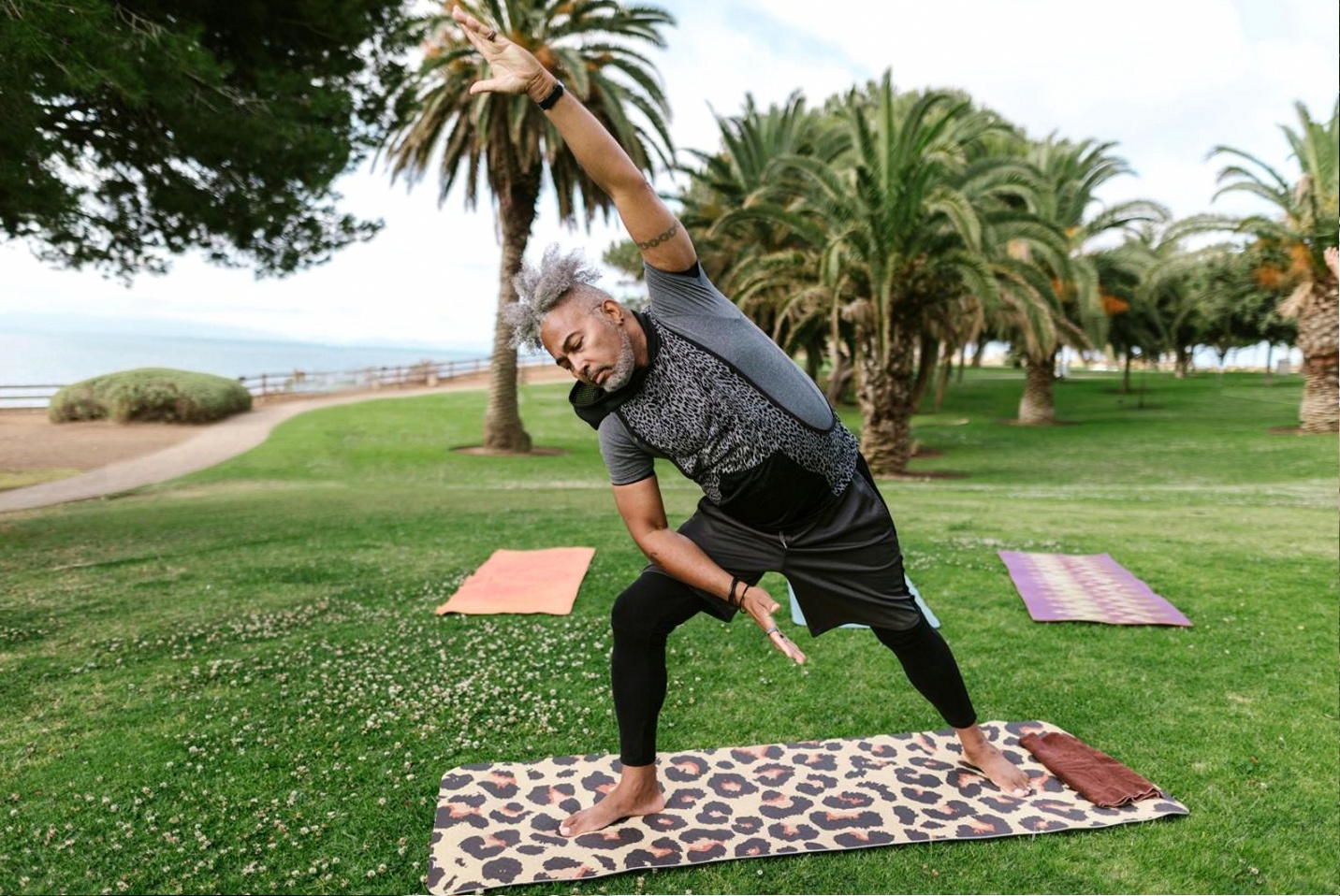 Instructor demonstrating a seated spinal stretch suitable for office workers